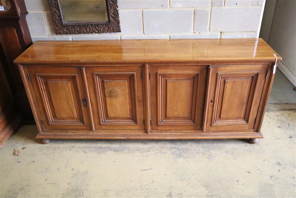 A 19th century French walnut four door panelled cupboard, width 210cm, depth 46cm, height 87cm